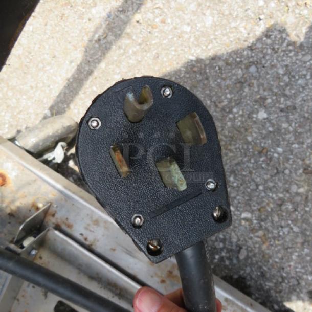 Power plug end for Spring USA model ICS348-26 induction cooking station, showing three prong design and used condition.