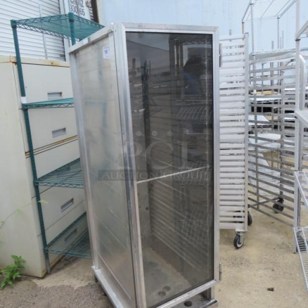 Aluminum holding cabinet on casters, single door, dimensions 20x31x66.5, with shelving. Used condition.