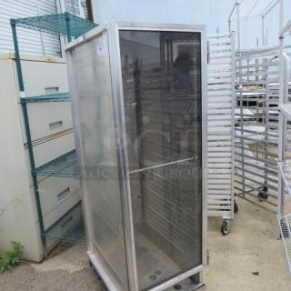 Aluminum holding cabinet on casters, single door, dimensions 20x31x66.5, with shelving. Used condition.
