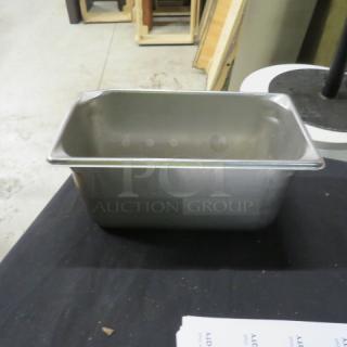 1/3 size, 6-inch deep stainless steel hotel pan. Used condition, ideal for buffets and catering. Multi-purpose kitchen tool.