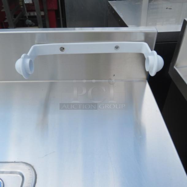 Corsair stainless steel portable sink with faucet, paper towel holder, 5-gallon fresh and 7-gallon waste tanks, on casters.