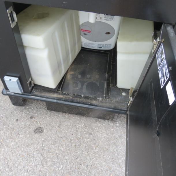 Corsair stainless steel portable sink with faucet, paper towel holder, 5-gallon fresh and 7-gallon waste water tanks, on casters.