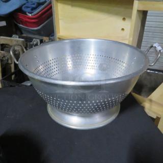 16.5-inch aluminum colander, perforated design, flared base, slightly tarnished finish, sturdy condition.