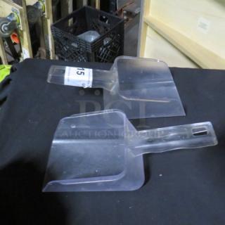 Clear poly scoops, labeled "15", in good condition on display table.