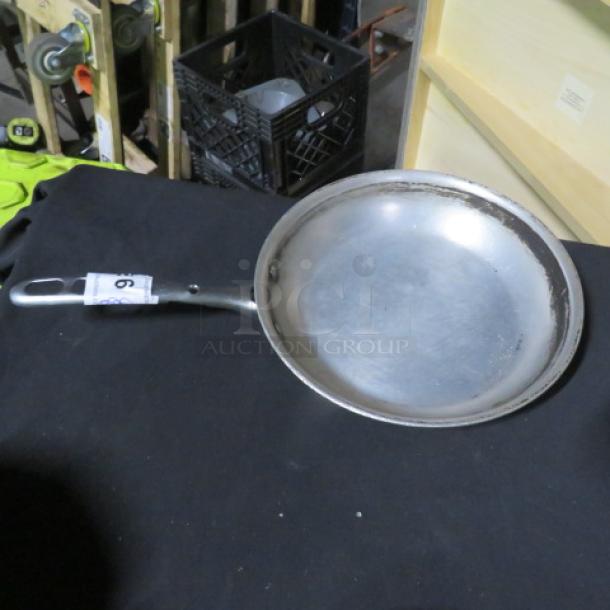 10.5-inch sauté pan with metal handle, lightly worn surface. Number "9" tag attached to handle.