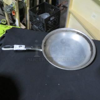 10.5-inch sauté pan with metal handle, lightly worn surface. Number "9" tag attached to handle.