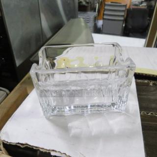 Case of 24 new glass sugar packet holders, clear glass, each with a wavy edge design, in pristine condition.