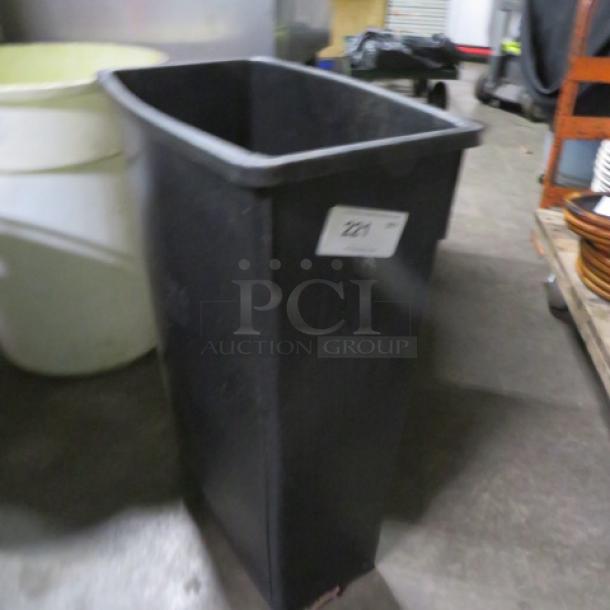 Black Slim Jim trash can, rectangular shape, used condition, label "221" attached, visible in storage setting.