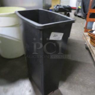 Black Slim Jim trash can, rectangular shape, used condition, label "221" attached, visible in storage setting.