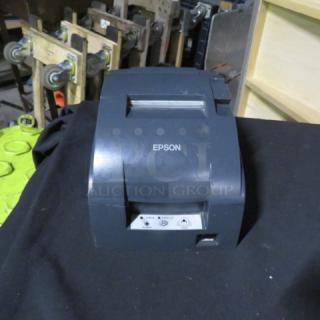 Epson Thermal Printer M188B, dark gray, front view, good condition, with visible logo and paper feed slot.