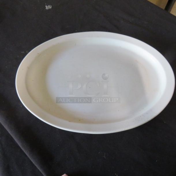 White oval platter, 13x10 inches, slight wear. Smooth surface, no visible cracks. Simple, versatile design.