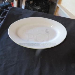 White ceramic platter, 12.5x9 inches, oval shape, smooth finish, gently used condition. No visible markings or labels.