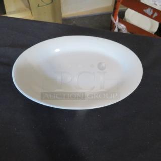 White ceramic platter, 10x7 inches, oval shape, smooth finish, clean condition. No visible markings or brand labels.