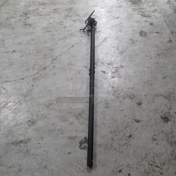 Metal TV mount, black, adjustable length, suitable for wall installation. Shows minor wear, ideal for flat-screen TVs.