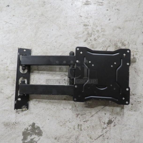 Black metal TV mount with adjustable arms and wall brackets, in good condition, designed for flat-screen installation.