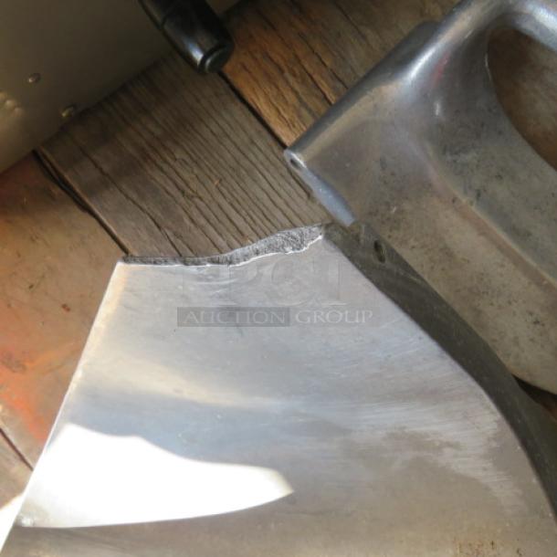 Metal component labeled "Pelican Head," showing a visible crack, sold for parts only. Appears worn, photographed on wooden surface.