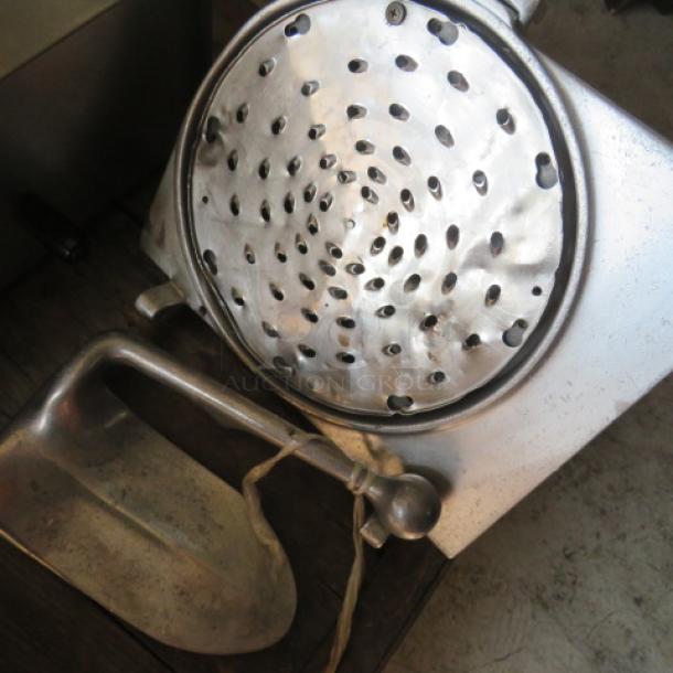 Metal pelican head with visible crack, perforated surface, and attached handle. Listed for parts only.