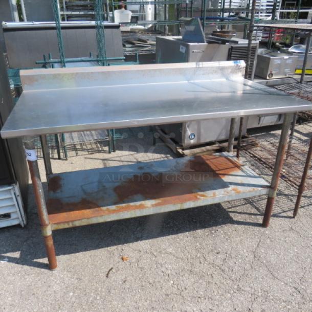 Stainless steel table with backsplash and undershelf, 60x30x38 inches, model #BK/VTTR56030, shows rust on undershelf.