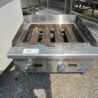 Cookrite natural gas charbroiler, 24x27.5x15 inches, no grates. Features control knobs, Cookrite logo, and item tag 257.