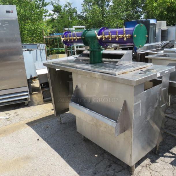 UNIQUE stainless steel beverage center with 10 tap beer tower and 30-inch bottle rail, dimensions 68x34x62, used condition.