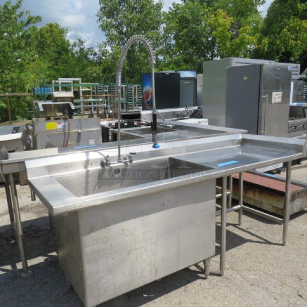 Stainless steel 1 compartment sink with faucet, hose sprayer, and right side drain table. Size 42x24x28. Model 90x30x41.
