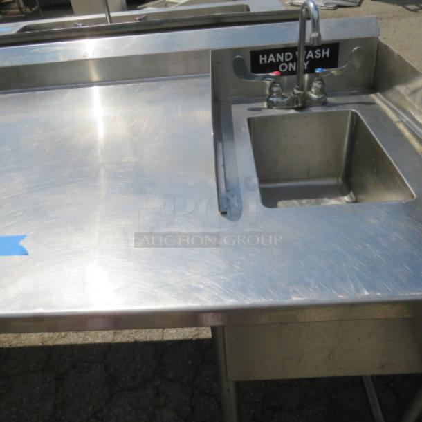L-shaped stainless steel workspace with a 10"x14"x8" handsink and 28"x28"x28" deep sink, both with faucets, 81"x105"x41".