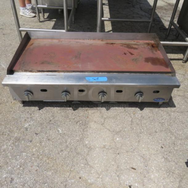 Natural gas griddle, 48x28x15, used, four burners, stainless steel, visible wear, rust on cooking surface, Blue Star label.