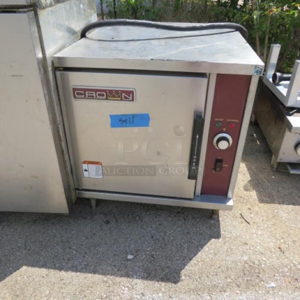 Crown Oven/Steamer, 24x28x28 inches, stainless steel, intact controls and branding. Good condition, labeled with blue tape "541".