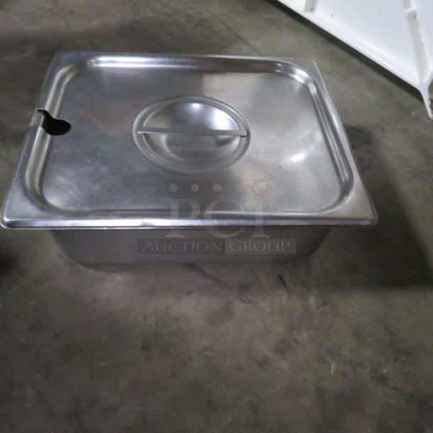1/2 size hotel pan with lid, 4 inches deep, stainless steel, used condition, ideal for catering or food service.