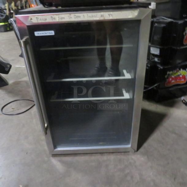 Tramontina glass door wine/bar cooler, model 80901/102, 115V, dimensions 20x22x31 inches, with shelving inside.