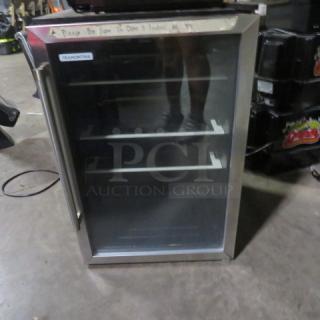 Tramontina glass door wine/bar cooler, model 80901/102, 115V, dimensions 20x22x31 inches, with shelving inside.