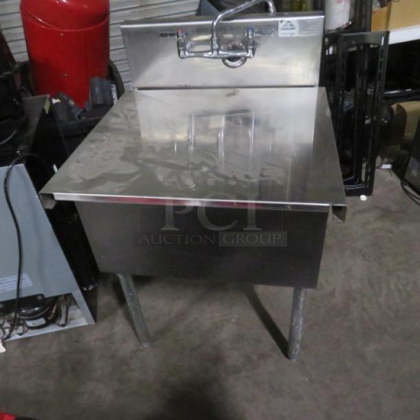 Stainless steel sink with faucet and cover, dimensions 26.5x25x41 inches, in used condition.