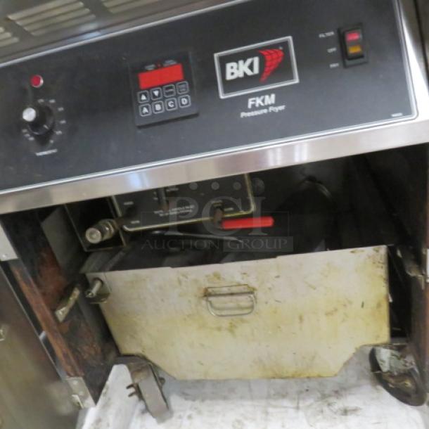 BKI FKM 75lb electric pressure fryer on casters, Model FKM-F. 208 Volt. Dimensions: 24x39x50 inches. Used condition, working when removed.