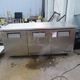 True TUC-72 3-door worktop refrigerator on casters, stainless steel, 72x30x35.5 inches, 115V, good condition, visible label.