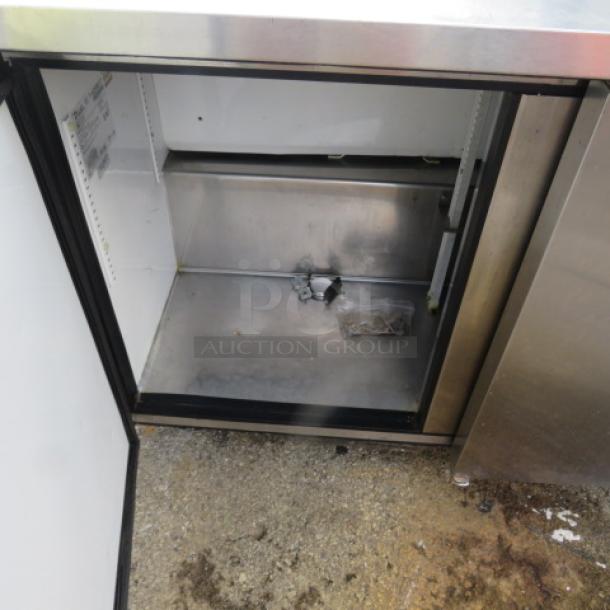 True TUC-72 3-door worktop refrigerator on casters, 72x30x35.5 inches, open door view, working condition, 115 volt.
