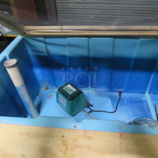 Blue live bait box, 77x36x34 inches, contains aerator and pipe. Good condition, ideal for fishing or aquatic use.