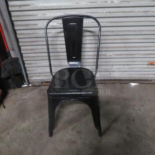 Black metal industrial-look chair, model 2XBID, in good condition. Simple backrest design, sturdy build.