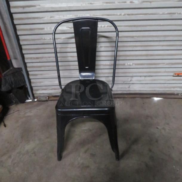 Black metal industrial chair, 2XBID model, featuring a sleek design with a curved backrest. Good condition.