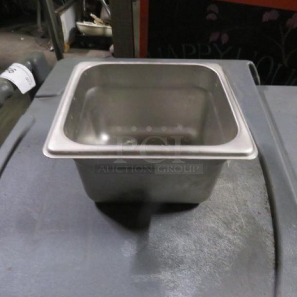 1/6 size, 4-inch deep stainless steel hotel pan in good condition, stamped "3XBID".