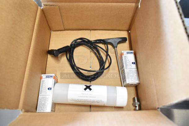 An open box with packaged accessory items, wires, and tools for Blodgett BCT-202 combi convection oven, new condition.