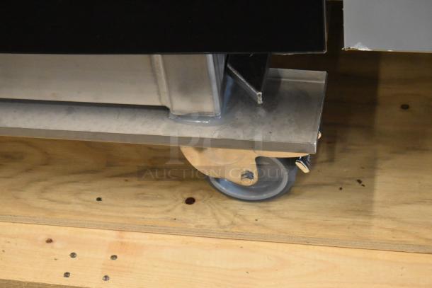 Close-up of a Blodgett BCT-202 combi convection oven's caster wheel, showing its sturdy stainless steel construction.