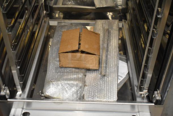 Brand new Blodgett BLCT-202 stainless steel combi convection oven, scratch and dent. Includes roll-in rack and metal pan transport rack. 