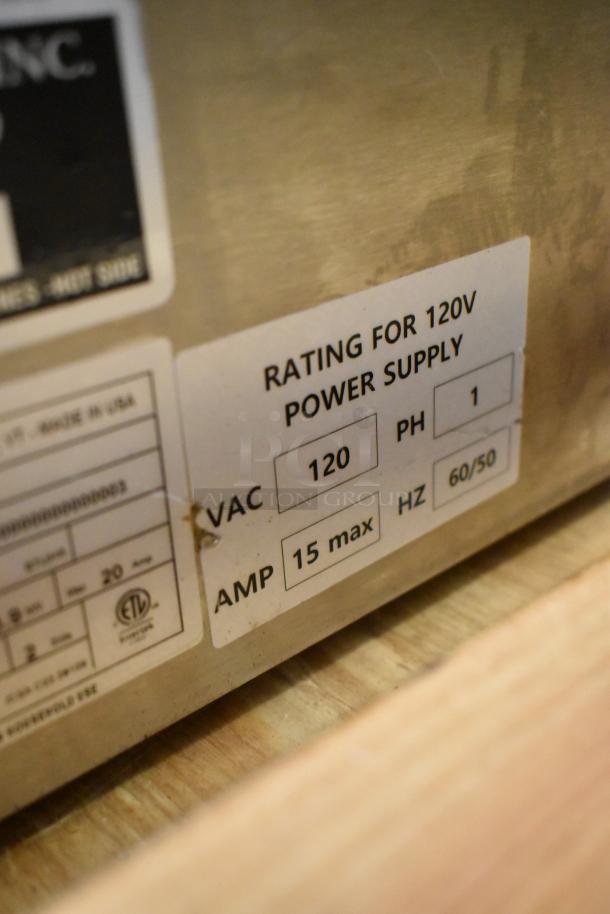 Close-up of a Blodgett BLCT-6E-H oven label showing a 120V power supply rating with 15 max amps. Stainless steel finish.