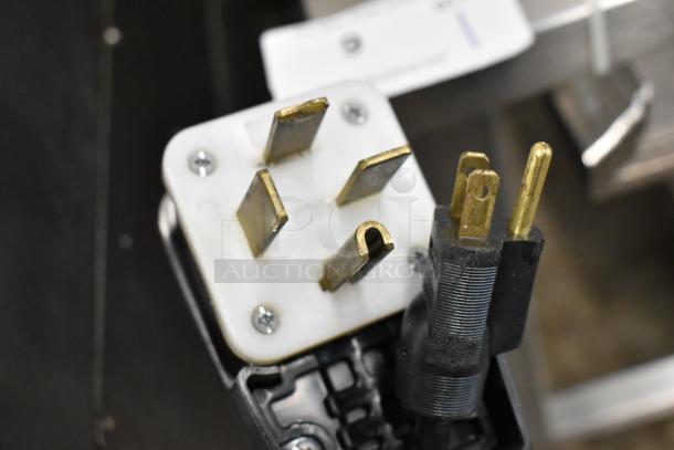 Close-up of electrical plug for Blodgett BLCT-6E-H oven, showing three-prong connection suitable for 208/240 volts, 3 phase.