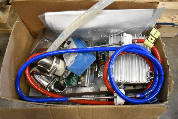 Box of assorted components and tubing for the Blodgett BLCT-6E-H oven, including red and blue hoses, connectors, and electronic parts.