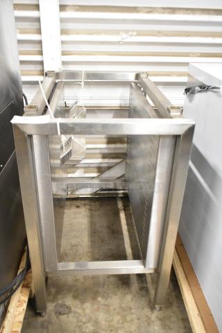 Brand new metal commercial pan rack with scratches and dents. Sturdy construction, ideal for kitchen use, visible structural integrity.
