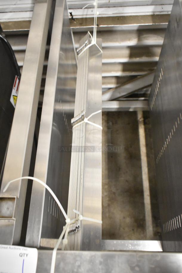 Brand new metal commercial pan rack with visible scratches and dents. Features slotted sides and secure ties. Ideal for kitchen use.