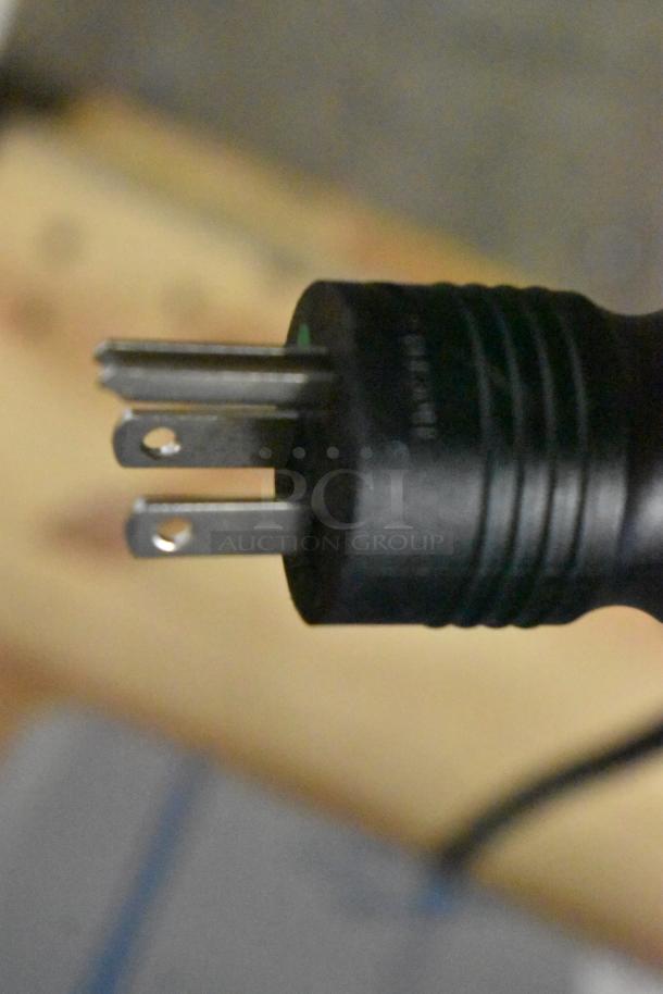 Close-up of a black three-prong plug, part of Blodgett CPE-gas oven; shows connection detail.