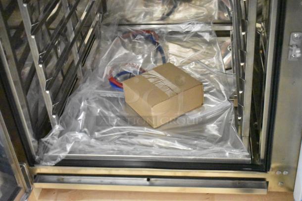 Brand new 2023 Blodgett CPE-gas 2.10/BLCT 102 stainless steel convection oven interior, view through door, includes metal rack.