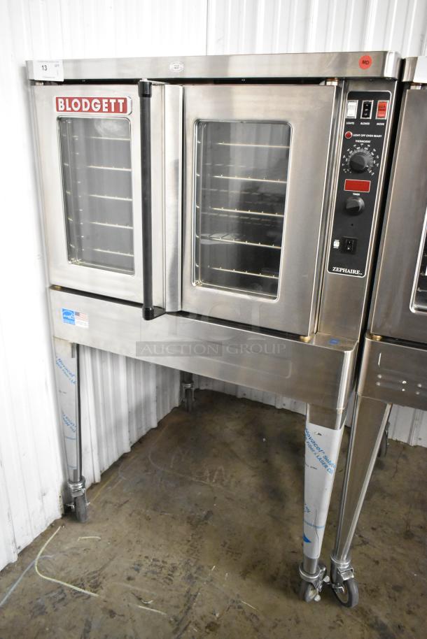 Brand new Blodgett Zephaire-200-E stainless steel convection oven with view-through doors, thermostatic controls, and casters.
